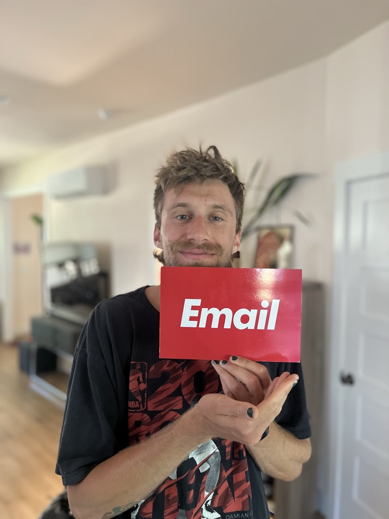 Holding a postcard that says Email