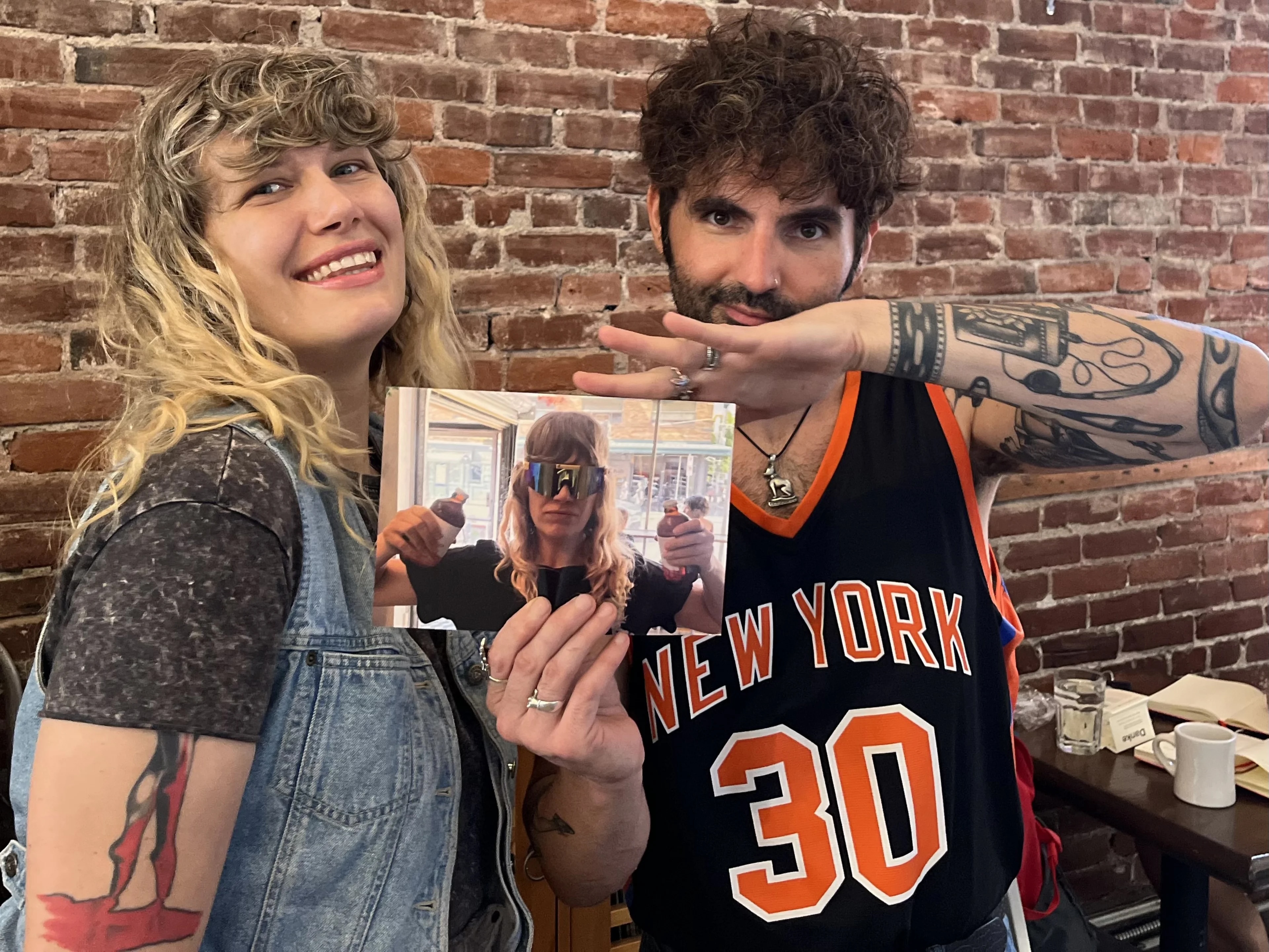 Friends holding a photo postcard
